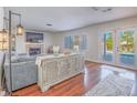 Cozy living room with hardwood floors, a fireplace, and access to the backyard pool area at 2732 Dune Cove Rd, Las Vegas, NV 89117