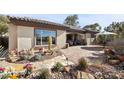 Expansive backyard patio featuring desert landscaping, comfortable seating, and desert views at 2749 Liberation Dr, Henderson, NV 89044