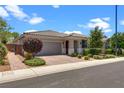 Beautiful one-story home featuring desert landscaping, a paved driveway, and a two-car garage under a sunny sky at 2915 Moulton Crest Ave, Henderson, NV 89044