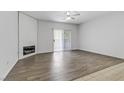 Bright living room with fireplace, ceiling fan, and sliding glass doors at 2975 Bluegrass Ln # 811, Henderson, NV 89074