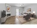 Staged living room featuring modern furniture, fireplace, and sliding glass doors at 2975 Bluegrass Ln # 811, Henderson, NV 89074