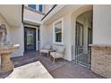 Cozy front entrance with seating area, decorative fountain, and wrought iron door at 3000 Hammerwood Dr, Las Vegas, NV 89135