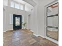 Grand foyer with high ceilings, a decorative front door, and stylish tile flooring at 3000 Hammerwood Dr, Las Vegas, NV 89135