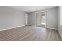 Spacious bedroom with sliding glass doors and wood-look flooring, offering ample natural light at 3236 Lahontan St, North Las Vegas, NV 89032