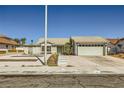 Single-story home featuring desert landscaping, a two-car garage, and a quaint front entryway at 335 Simon Bolivar Dr, Henderson, NV 89014
