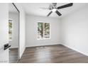 Bright bedroom featuring wood floors, a ceiling fan, and a large window that brightens the space at 404 Vassar Ln, Las Vegas, NV 89107