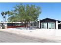 Charming single-story home featuring a well-maintained front yard with mature shade tree at 404 Vassar Ln, Las Vegas, NV 89107