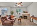 Cozy living room with a comfortable leather sofa, a fireplace, and lots of natural light at 50 Aura De Blanco St # 2104, Henderson, NV 89074