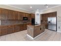 Spacious kitchen featuring granite counters, an island with seating, and stainless steel appliances at 5016 Wayfaring Tree Ave, Las Vegas, NV 89131
