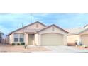 Single story home with desert landscaping, attached two car garage, and tile roof at 5112 Foggia Ave, Las Vegas, NV 89130