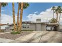 Charming single-story home featuring a covered driveway, desert landscaping, and a welcoming front entrance at 5217 Champions Ave, Las Vegas, NV 89142