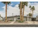 Beautiful single-story home featuring desert landscaping, charming walkway, and an attached carport at 5217 Champions Ave, Las Vegas, NV 89142