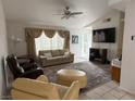 Cozy living room with comfortable seating, ceiling fan, and large windows with draping curtains at 5424 Comchec Way # 101, Las Vegas, NV 89108