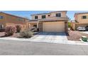Charming two-story home with a tile roof, stone accents, and a well-manicured front yard at 6052 Puesta Del Sol St, North Las Vegas, NV 89081