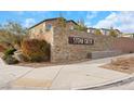 Stone Creek community entrance with brick and stone wall with mature landscaping at 7115 Calvert Cliffs St, North Las Vegas, NV 89084