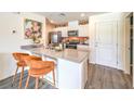 Stylish kitchen boasts white cabinets, a breakfast bar, and stainless steel appliances at 7375 Hayes Harbor Ct # Lot 210, North Las Vegas, NV 89084