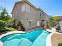 Backyard pool and patio area, perfect for outdoor entertaining and relaxation at 10612 Gum Tree Ct, Las Vegas, NV 89144