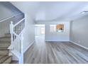 Spacious living room featuring open floor plan, new light wood floors, and natural light at 11185 Saddle Iron St, Las Vegas, NV 89179