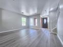 Bright, airy living room with wood-look floors and a view of the front yard at 11185 Saddle Iron St, Las Vegas, NV 89179