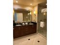 Bathroom boasts a double sink vanity with granite countertops and a glass-enclosed shower at 125 E Harmon Ave # 2918, Las Vegas, NV 89109