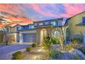 Charming home featuring a brick driveway, tidy front landscaping and beautiful evening skies at 12816 Alcores St, Las Vegas, NV 89141