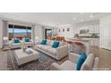 Bright living room with modern furniture and a large sliding glass door showcasing scenic mountain views at 1398 Pin Cushion Rdg, Mesquite, NV 89034
