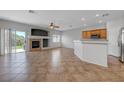 Spacious living room featuring a fireplace, tile flooring, and open layout to the kitchen at 1574 Ward Frontier Ln, Henderson, NV 89002