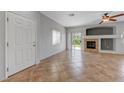 Open-concept living room with fireplace and sliding glass doors to patio at 1574 Ward Frontier Ln, Henderson, NV 89002