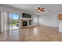Bright living room boasts tile floors, fireplace, and sliding glass door access to backyard at 1574 Ward Frontier Ln, Henderson, NV 89002
