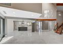 Bright open-plan living space with high ceilings, marble floors, and a modern kitchen at 1600 Becke Cir, Las Vegas, NV 89104