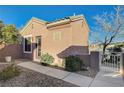 Cozy home featuring a tiled roof, side gate, and meticulously maintained desert landscaping at 2039 Colvin Run Dr, Henderson, NV 89052
