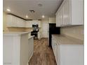 Spacious kitchen featuring white cabinets, stainless steel appliances, and ample counter space at 209 Copper Pine Ave, North Las Vegas, NV 89031