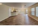 A bright and spacious living room featuring modern wood-look flooring and natural light streaming through large windows at 209 Copper Pine Ave, North Las Vegas, NV 89031