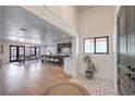 Inviting home foyer showcases stylish tile flooring, an open floor plan, and views into the dining and kitchen areas at 210 E Longacres Dr, Henderson, NV 89015