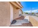 Charming front entrance with welcoming mat and sidewalk leading up to the door at 2103 Falcon Crest Ave, North Las Vegas, NV 89031