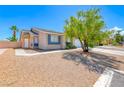 Inviting single-story home featuring a xeriscaped front yard and blue trimmed windows at 2103 Falcon Crest Ave, North Las Vegas, NV 89031