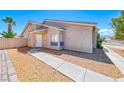 Well-maintained single-story home with stucco exterior, xeriscape yard, and neat landscaping at 2103 Falcon Crest Ave, North Las Vegas, NV 89031