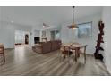 Bright open-concept living room featuring lots of natural light and hardwood flooring at 2325 Windmill Pkwy # 1023, Henderson, NV 89074
