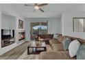 Cozy living room with fireplace, hardwood floors, and sliding glass doors to backyard at 2325 Windmill Pkwy # 1023, Henderson, NV 89074