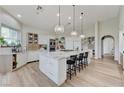 Spacious kitchen features a large island with seating, pendant lighting, and stainless steel appliances at 2345 Villandry Ct, Henderson, NV 89074