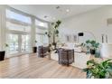 Bright living room features high ceilings, large windows with sheer curtains, and wood-look floors at 2345 Villandry Ct, Henderson, NV 89074