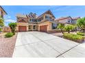 Beautiful two-story home with a three car garage and well-manicured front yard landscaping at 2521 Cattrack Ave, North Las Vegas, NV 89081