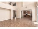Spacious living room with tile flooring and a seamless transition to the kitchen and dining area at 2521 Cattrack Ave, North Las Vegas, NV 89081