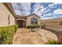 Cozy courtyard area with stamped concrete, privacy landscaping, and decorative metal lawn furniture at 3071 Lake Barkley Rd, Henderson, NV 89052
