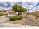 Exterior shot of home, showcasing well-maintained desert landscaping, gravel and rock accents, and mature trees at 3071 Lake Barkley Rd, Henderson, NV 89052