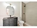 Modern bathroom features a stand-up shower with sleek fixtures, a dark vanity, and accent mirror at 3318 N Decatur Blvd # 1107, Las Vegas, NV 89130