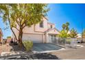 Attractive two-story home with a two-car garage, tidy landscaping, and a secure white metal fence at 3954 Crystal Trip Ct, Las Vegas, NV 89129
