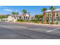 Well-maintained community area with clear blue pool, palm trees, and landscaping at 4559 Dover Straight St, Las Vegas, NV 89115