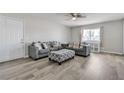 The staged living room features modern sofas, ottoman, and wood-look floors at 4629 San Cir, Las Vegas, NV 89120