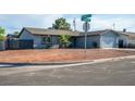 Street view of a single-story home with desert landscaping, a two-car garage, and neutral paint at 4797 E Imperial Ave, Las Vegas, NV 89104